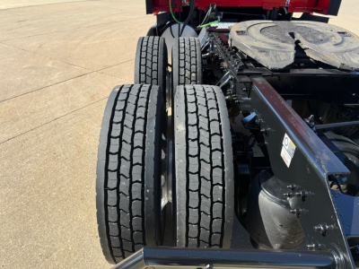 Kenworth T680 wheel configuration showing dual rear axles and chassis mount area with circular spare on the frame.