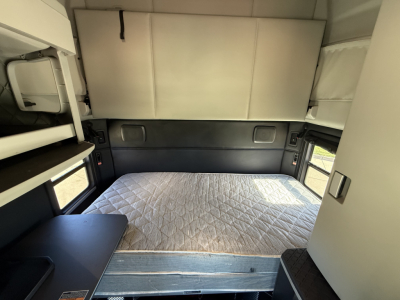Kenworth T680 sleeper cab interior with bed and storage compartments visible