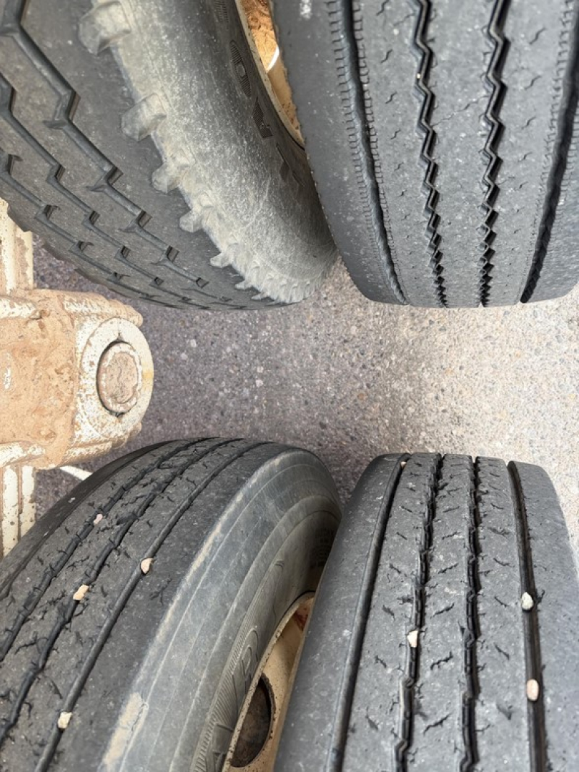 Trailer axle with dual treads showing tire treads and rim details for a 2013 Ranco single point spring bottom dump trailer.