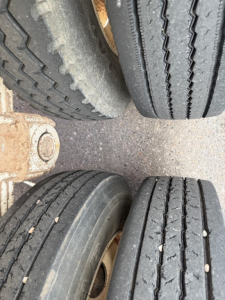 Trailer axle with dual treads showing tire treads and rim details for a 2013 Ranco single point spring bottom dump trailer.
