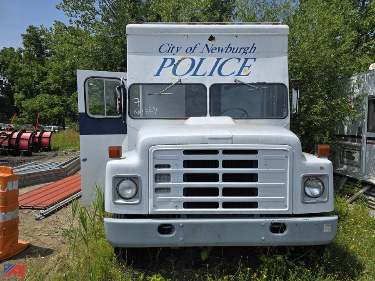 International 1853 mobile police station truck front view showing City of Newburgh POLICE signage on cab and grille with two round headlights.