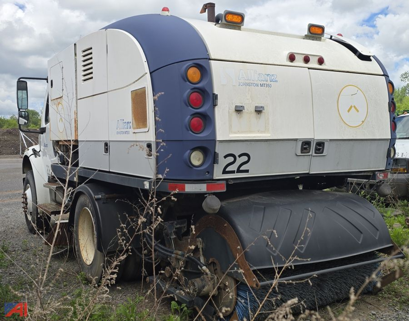 Tractor-trailer style Freightliner M2 106 road sweeper rear view showing large sweeping attachment and rear bumper with the number 22.