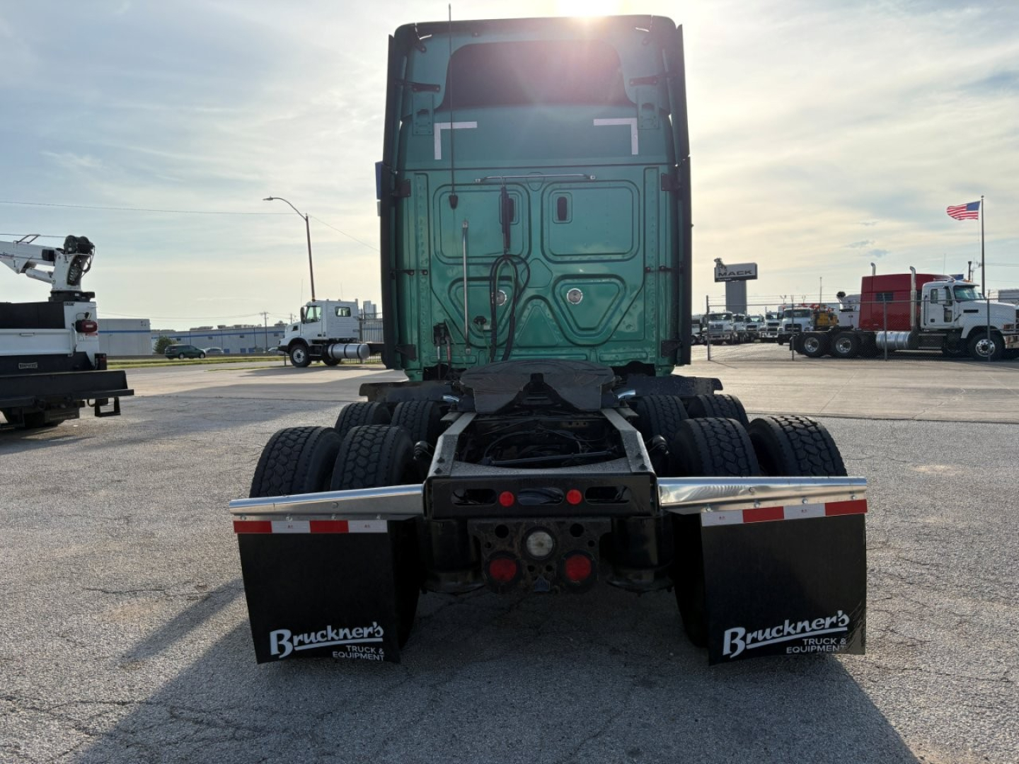 Freightliner Cascadia 126 truck rear view showing fifth wheel, rear mud flaps, and dual rear wheels.
