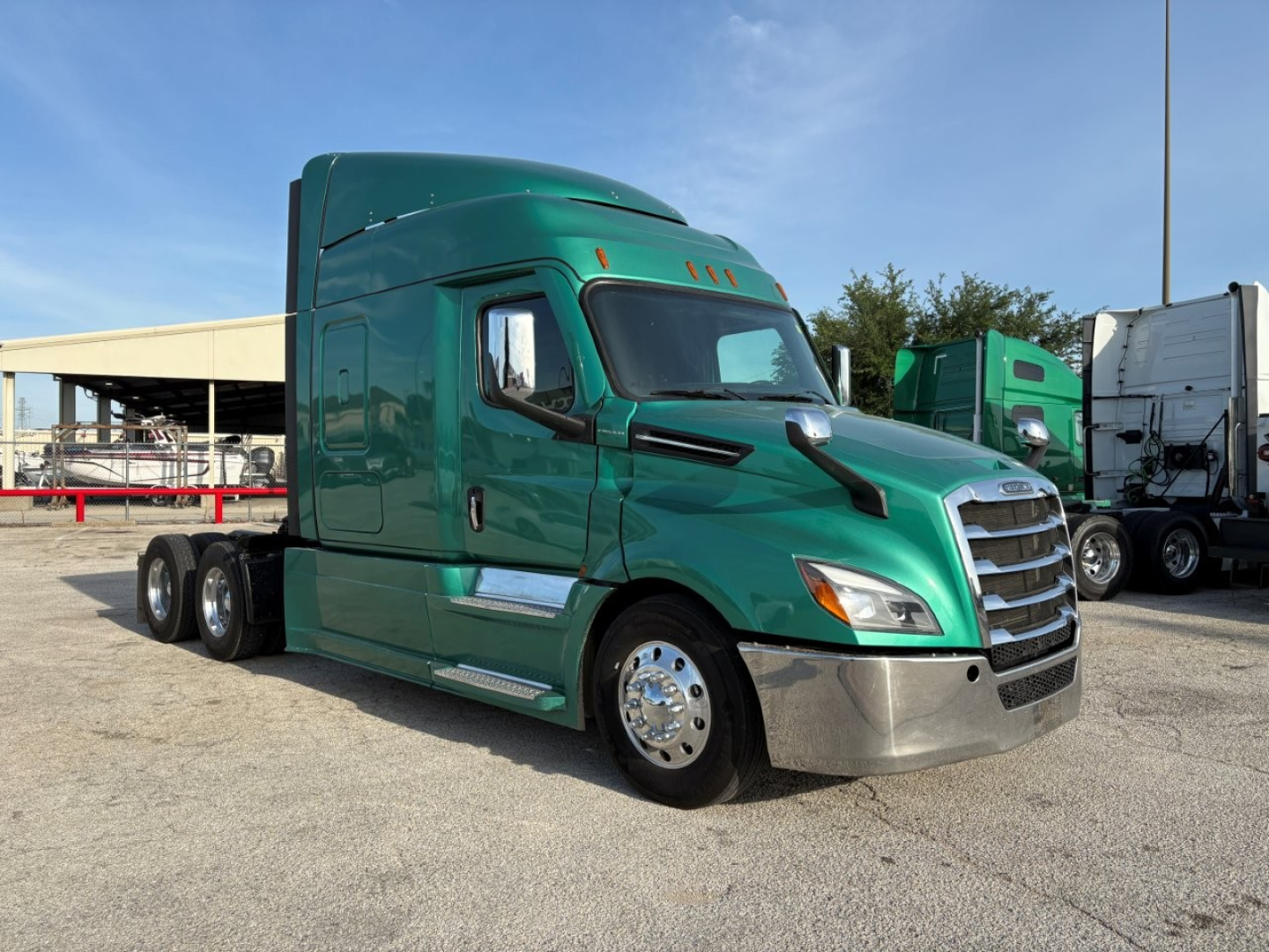 Green Freightliner Cascadia 126 sleeper truck side view showing cab and dual rear axles with chrome bumper and wheels.