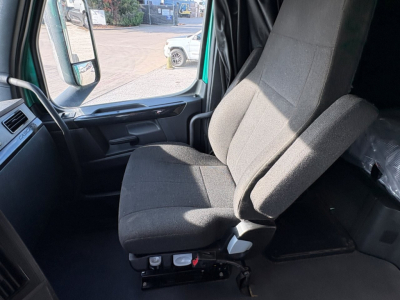 Tractor-trailer cab interior showing driver and passenger seats in a Freightliner Cascadia 126 truck.