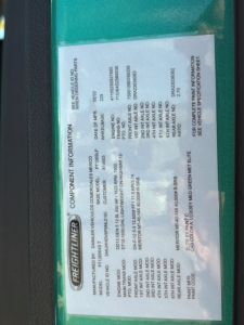 Vehicle information label inside Freightliner Cascadia 126 truck window showing VIN, stock number, category, type, and condition.