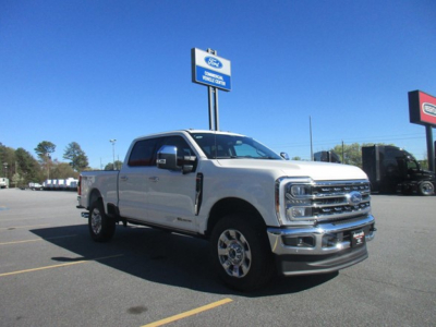 2026 Ford F350 pickup truck in a dealership lot showing front and side view with chrome grille and headlights.