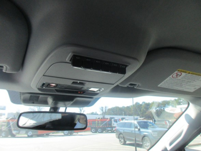 Interior overhead console with sunglasses holder and map lights showing rearview mirror and windshield view.