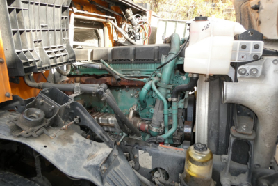 Volvo VNM64T engine bay showing diesel engine with cooling reservoir and surrounding components.