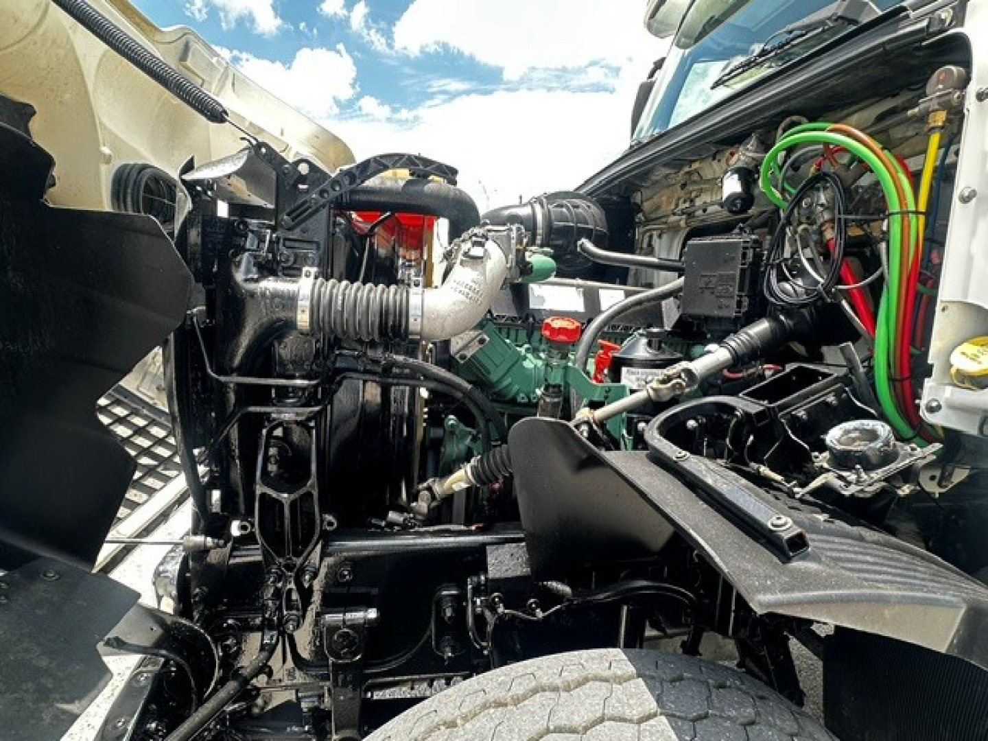 Volvo VHD engine bay showing hydraulic lines, turbocharger, and various hoses in a rolling stock configuration