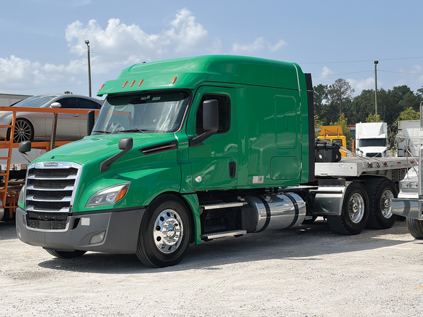 Green Freightliner Cascadia126 tractor truck side view with sleeper cab and chassis, STL cab, front grille, and dual rear wheels.