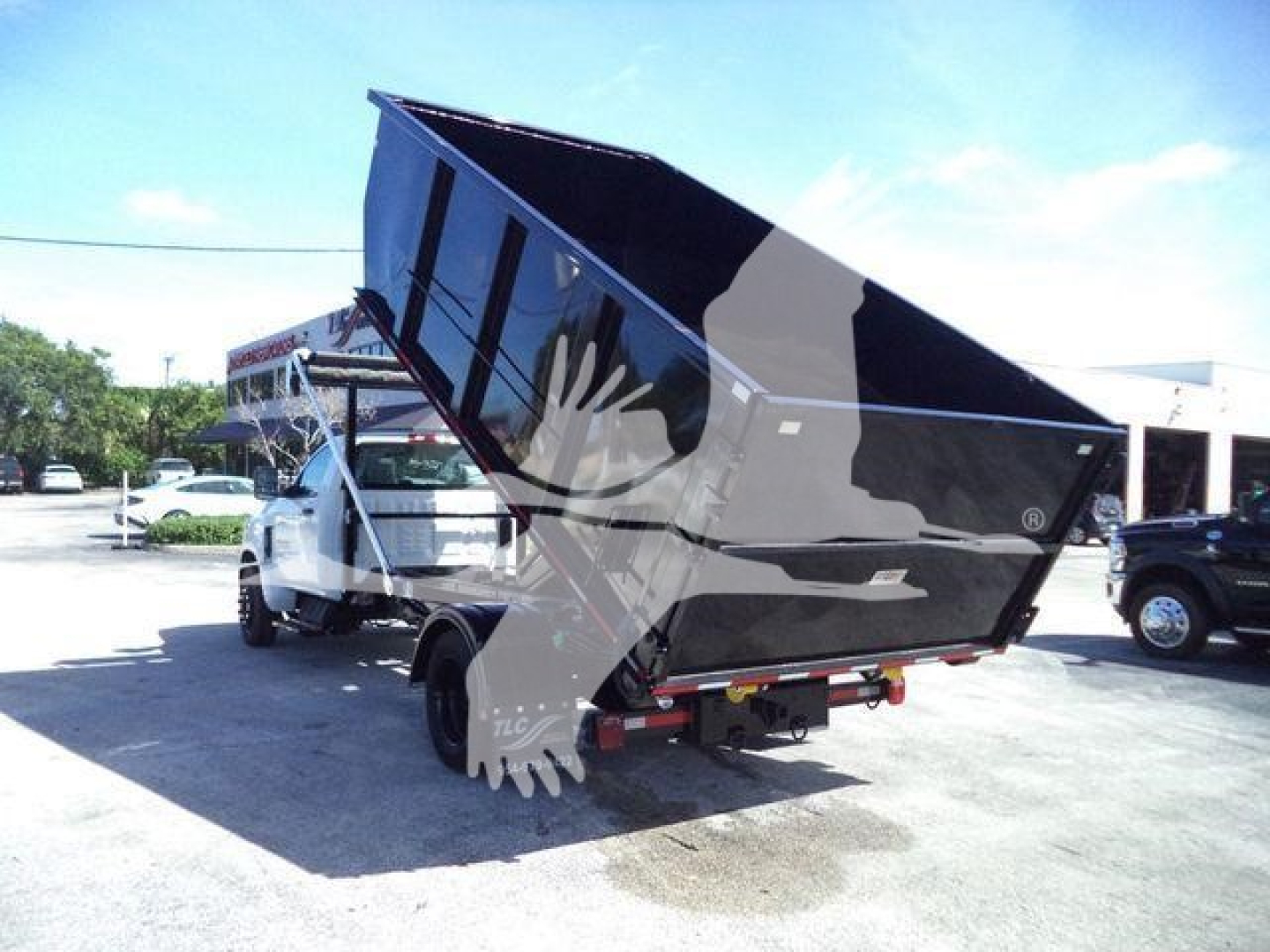 Dump truck bed in raised position showing cargo area and rear view of hydraulic system