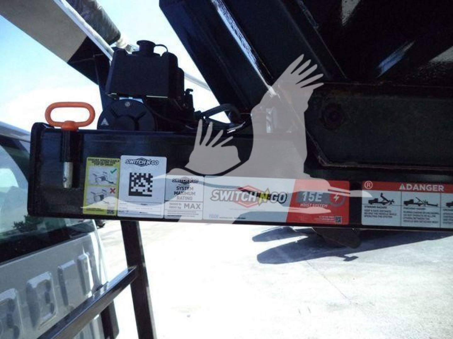 Truck hitch or tow equipment on a 2023 Chevrolet Silverado 6500HD, showing a hydraulic component with labels and an orange handle.