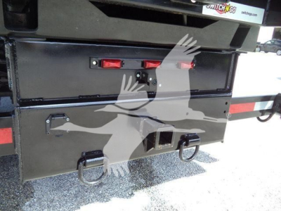 Truck rear storage box on a 2023 Chevrolet Silverado 6500HD rollover truck showing metal compartments and tie-down rings.