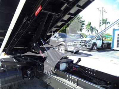 Sheeted hydraulic mechanism of a 2023 Chevrolet Silverado 6500HD roll-off truck showing chassis and hydraulic components.