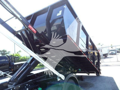 Truck bed in raised position showing hydraulic mechanism, side of 2023 Chevrolet Silverado 6500HD roll-off with black paint and reflective setup.