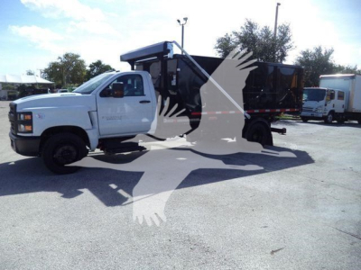 Truck cab and roll-off bed with graphic watermark showing a white silhouette of a bird in flight.