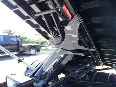 Chevrolet Silverado 6500HD truck bed showing hydraulic tilt mechanism and raised cargo bed in a roll-off configuration.
