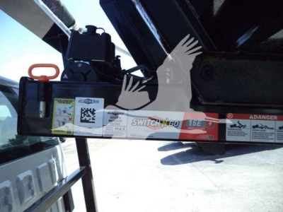 Truck hitch or tow equipment on a 2023 Chevrolet Silverado 6500HD, showing a hydraulic component with labels and an orange handle.