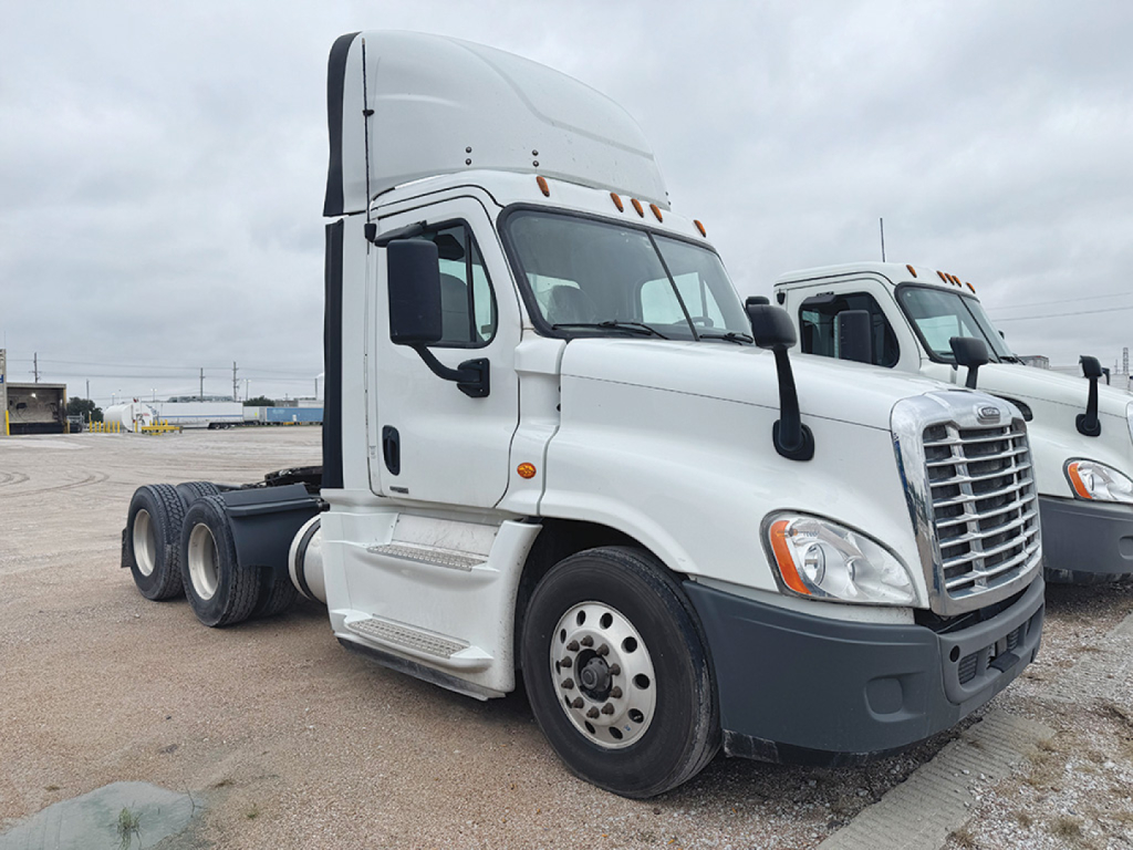 Freightliner Cascadia Evolution 2017 tractor truck seen in a lot, front-left view with white cab, dual rear axles, black bumper, and chrome grille.