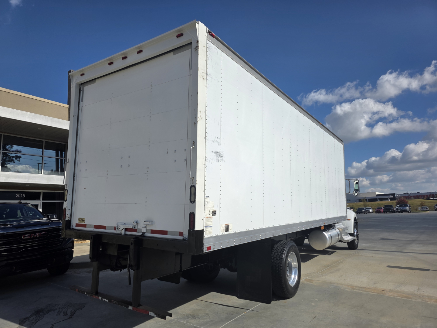 Peterbilt 337 box truck rear and side view showing cargo box and dual rear wheels.