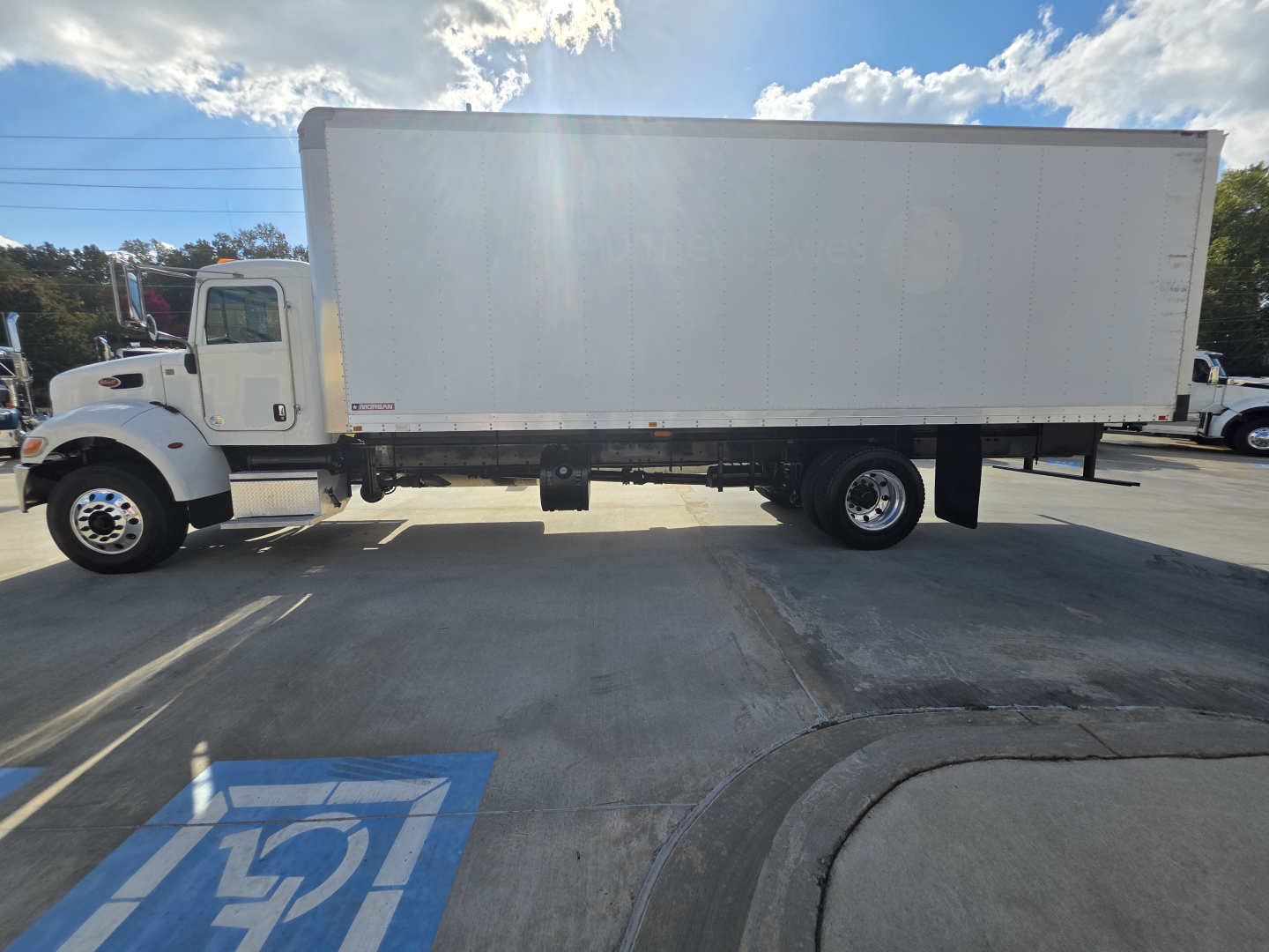 Peterbilt 337 box truck side view with large white cargo box and cab, showing a long wheelbase and dual rear axles.