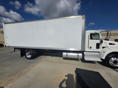 Peterbilt 337 box truck side view showing white cargo box and front cab with chrome fuel tank and wheel well.