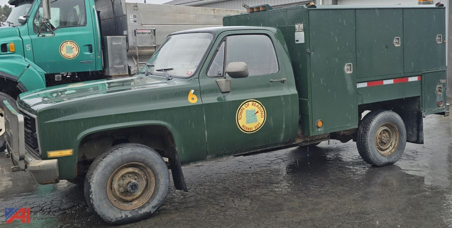 1986 Chevrolet D30 utility box pickup truck in service livery with a green crew cab and utility box, side emblem, and yellow number 6 on front fender.