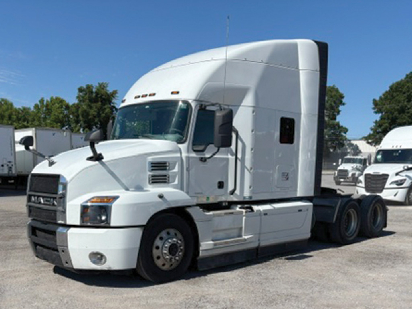 2022 Mack Anthem tractor-trailer side view showing conventional sleeper cab and fuel tanks.