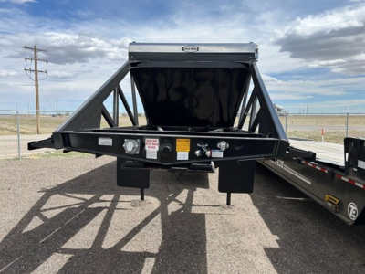 Ranco Versa Vale dump trailer A-frame hitch showing front loading area with signs and connectors on the frame.