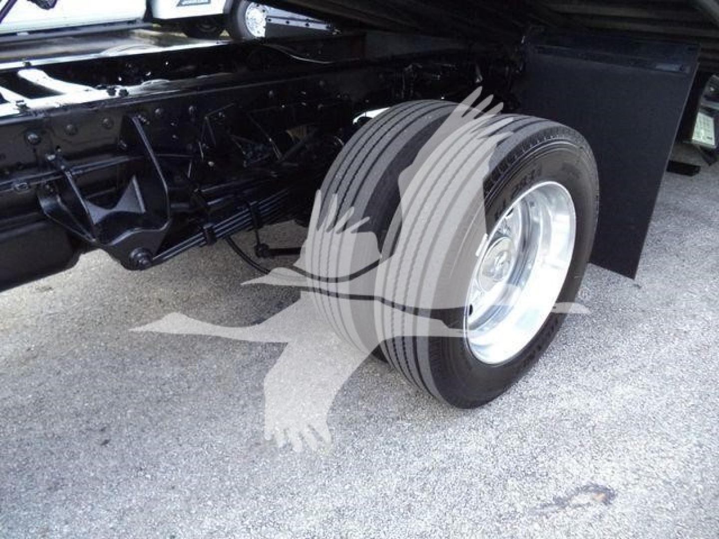 Truck chassis with dual rear wheels and suspension components visible in a Ram 5500 setup.