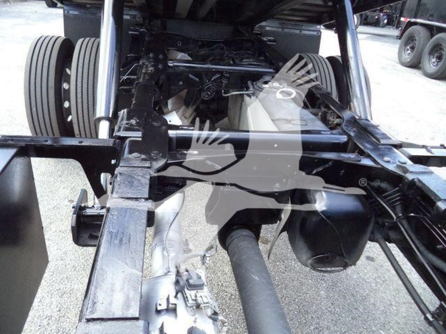 Ram 5500 chassis view showing frame rails, drive shaft, rear suspension, and wheels in a rollback truck.