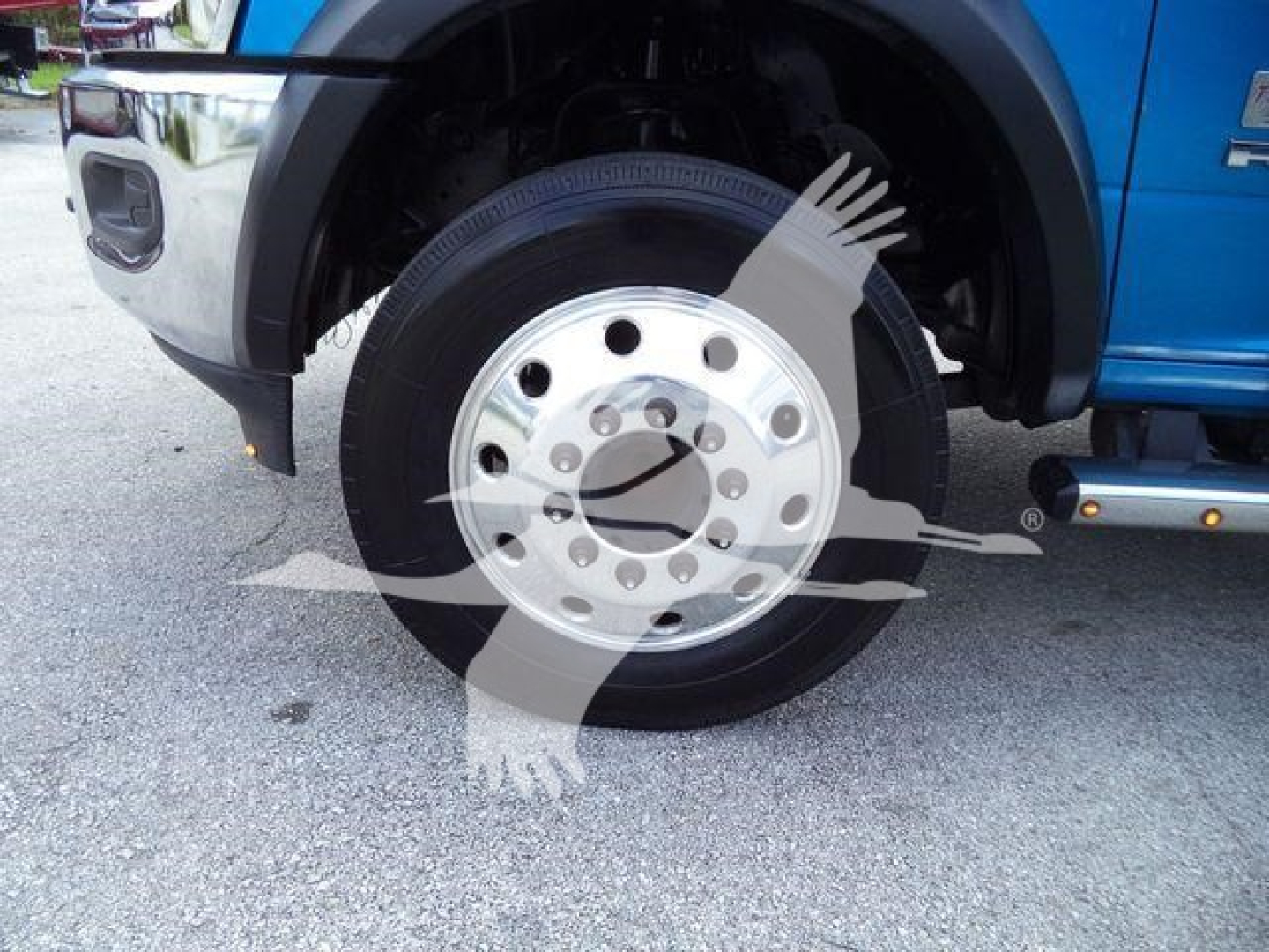 Ram 5500 front wheel and fender with logo and chrome hubcap visible