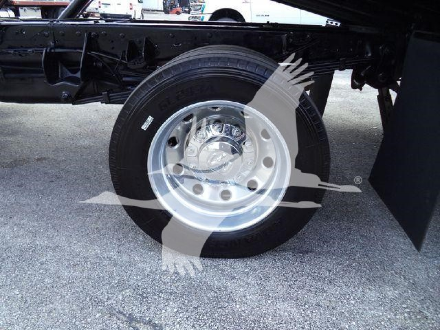 Wheel and suspension area of a 2022 Ram 5500 SLT rollback truck showing tire and chrome hubcap with surrounding chassis.