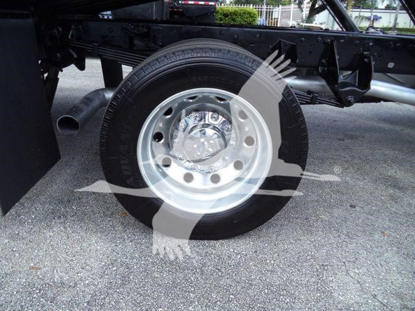 Ram 5500 wheel and suspension undercarriage view showing front tire and chrome hubcap with wheel well and frame components.