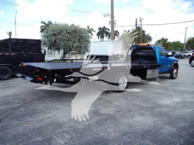 2022 Ram 5500 SLT rollback truck with flatbed and blue cab, side view.