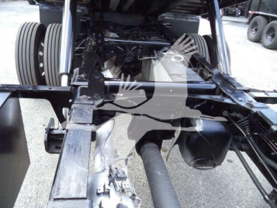 Ram 5500 chassis view showing frame rails, drive shaft, rear suspension, and wheels in a rollback truck.