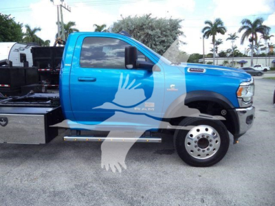 Ram 5500 rollback truck in blue, side view showing front wheel, side steps, and hydraulic bed equipment.