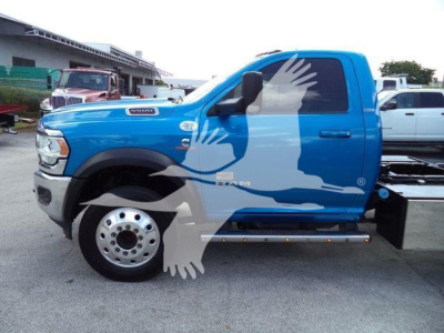 Ram 5500 truck side view showing blue cab, black side mirror, and chrome wheels.