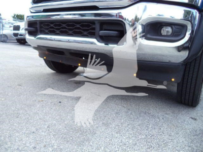 Front view of a 2022 Ram 5500 SLT truck with chrome grille, headlights, and bumper; visible front wheel and lower bumper area.