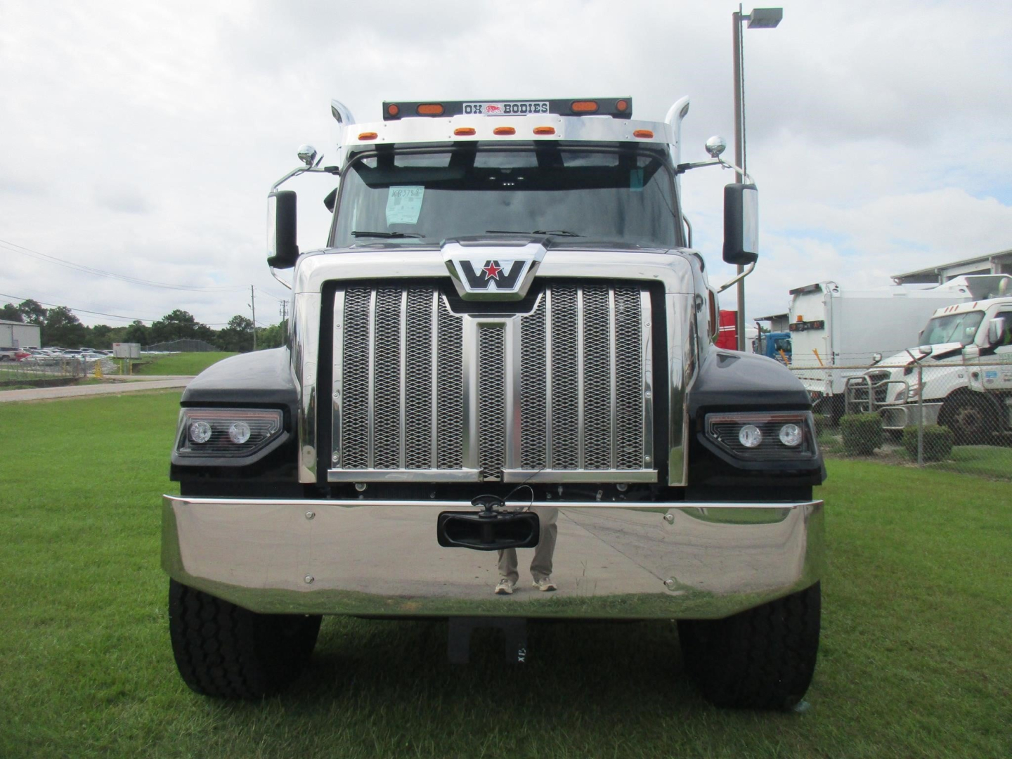 Western Star 49X dump truck front view showing large chrome grille, dual headlights, and bumper.