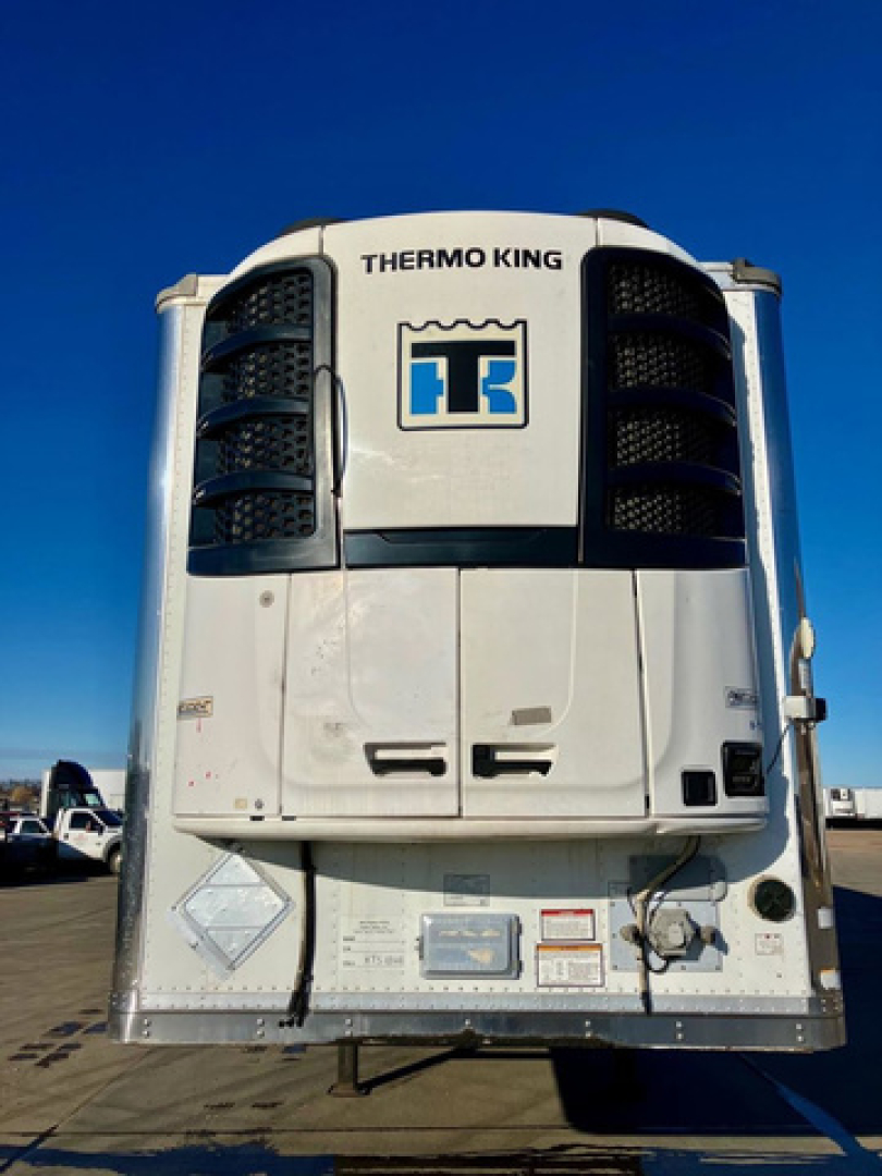 Thermo King refrigerated trailer unit mounted on front of Great Dane trailer, white with black grille vents and Thermo King logo visible.
