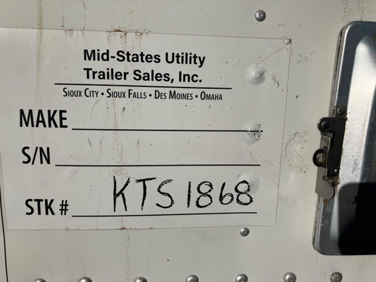 Reefer trailer rear door with Mid-States Utility Trailer Sales, Inc. label showing stock number KTS1868 and handwritten STK # KTS1868 on white plate.