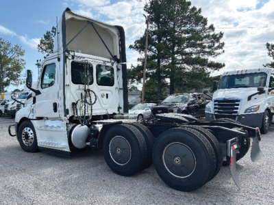 Freightliner Cascadia126 tractor with missing trailer showing side view, dual rear axles, white cab, no trailer attached.