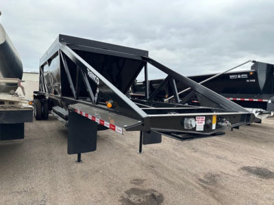Ranco LW21-40 dump trailer showing steel frame, black paint, side rails, and landing gear in a parking lot.