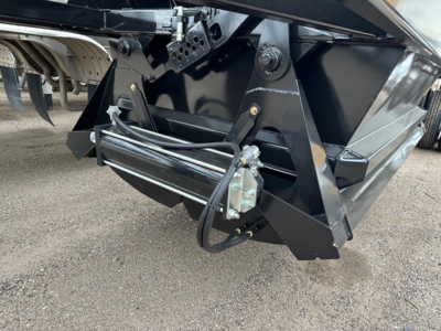 Ranco LW21-40 dump trailer hitch area showing hydraulic hoses and mounting hardware attached to a black steel frame.