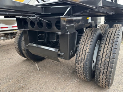 Ranco LW21-40 trailer undercarriage showing tandem axles and black steel frame with mounting brackets and spare tire clearance.