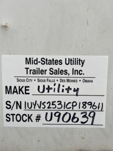 Mid-States Utility Trailer Sales plate on a van showing MAKE Utility, S/N 1UYVS2531CP189611, STOCK U90639.