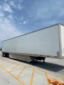 Trailer with elevated landing gear and blank side panels showing a long utility trailer.