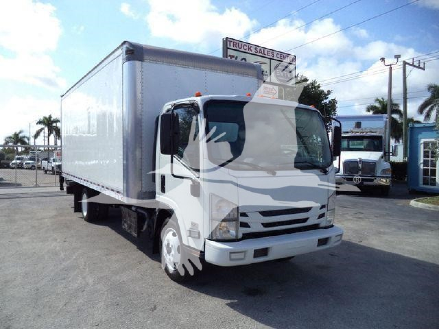 Isuzu NPR 2019 box truck in service showing cargo box and cab, side angle, stock number 210707FM visible in lot.